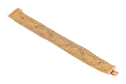 Lot 68 - A woven mesh bracelet with sapphire and...