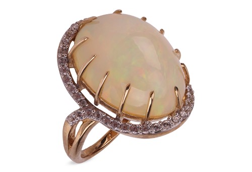 Lot 34 - An Ethiopian opal halo ring in 9ct gold,...