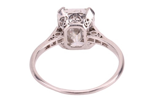 Lot 76 - An emerald-cut diamond solitaire ring, the...