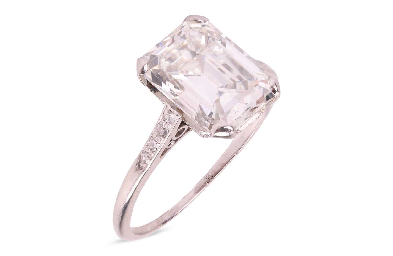 Lot 76 - An emerald-cut diamond solitaire ring, the...