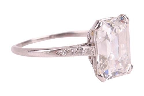 Lot 76 - An emerald-cut diamond solitaire ring, the...