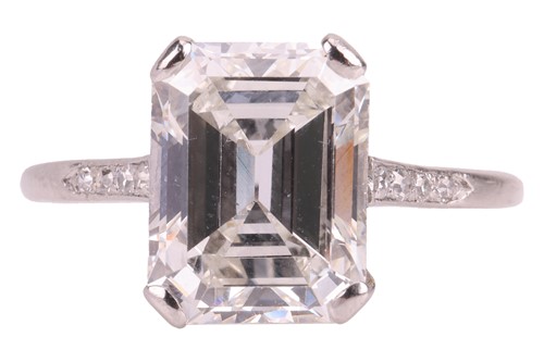Lot 76 - An emerald-cut diamond solitaire ring, the...