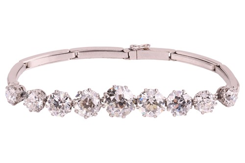 Lot 77 - A nine-stone graduated diamond bracelet, with...