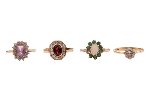 Lot 8 - Four gem-set rings in 9ct gold; a CZ solitaire,...