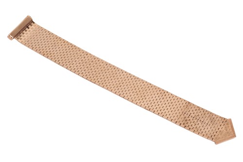 Lot 103 - A jarretière slide bracelet, comprising a...