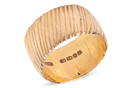 Lot 113 - An 18ct gold band ring, the textured band,...