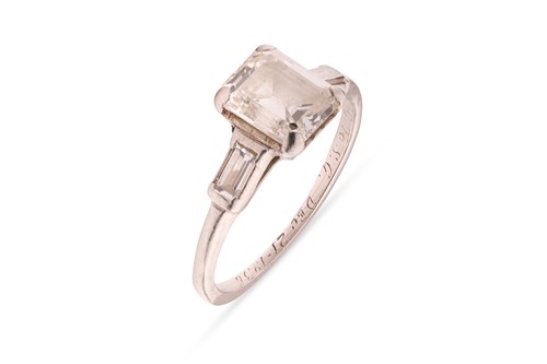 Lot 90 - An emerald-cut diamond solitaire ring,...