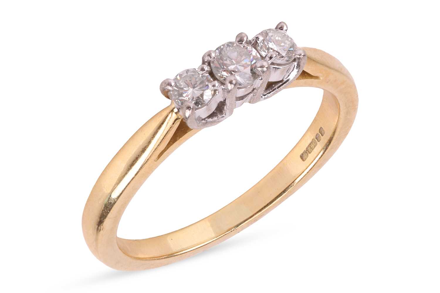 Lot A diamond three stone ring, comprising three...