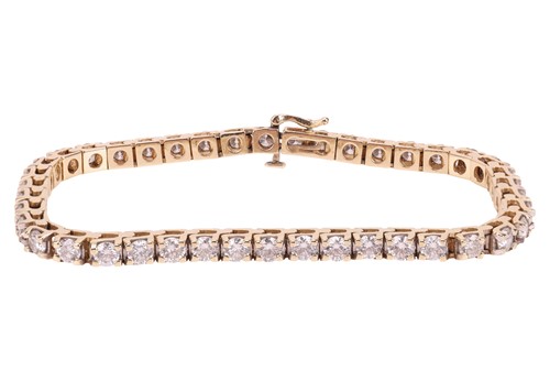 Lot 294 - A diamond tennis bracelet, featuring forty-two...