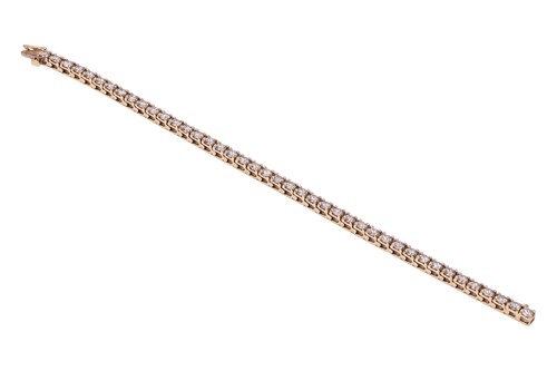 Lot 294 - A diamond tennis bracelet, featuring forty-two...