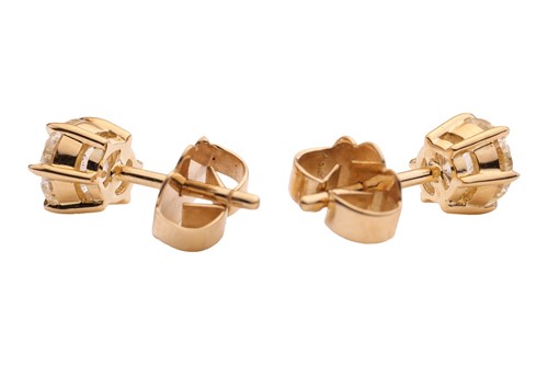 Lot 293 - A pair of diamond stud earrings, with a total...
