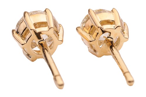 Lot 293 - A pair of diamond stud earrings, with a total...