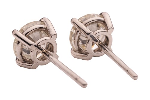 Lot 299 - A pair of diamond stud earrings, with a total...