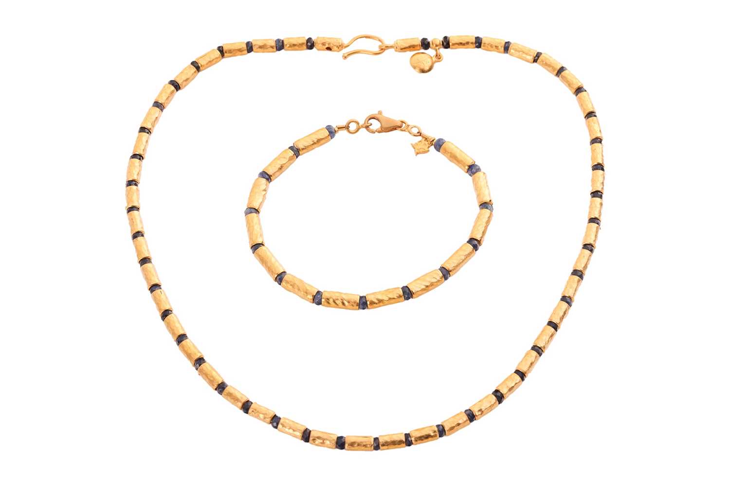 Lot 125 - A sapphire bead necklace and bracelet suite by...