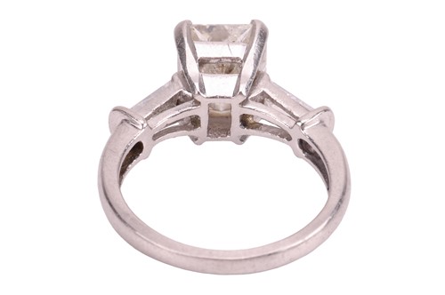 Lot 263 - A radiant-cut diamond ring, the central...