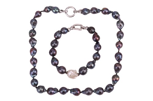 Lot 23 - A baroque pearl necklace and matching bracelet,...