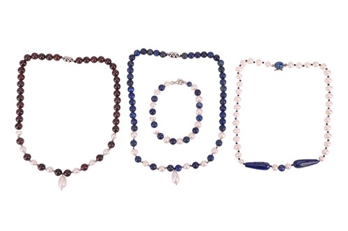 Lot 104 - A group of necklaces and a bracelet, the first...