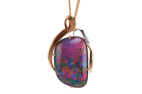 Lot 121 - An opal triplet pendant, containing a...