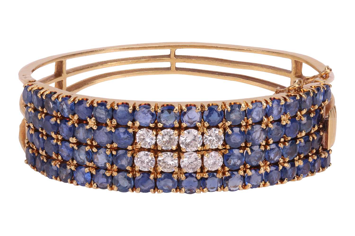 Lot 77 - A sapphire and diamond hinged bangle,...