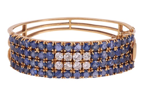 Lot 77 - A sapphire and diamond hinged bangle,...