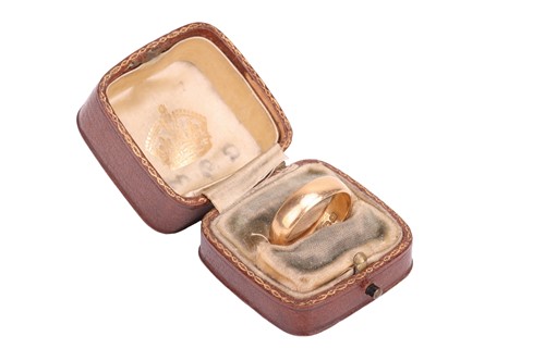 Lot 44 - A wide wedding band in 18ct yellow gold, the...