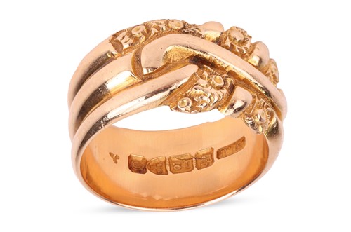 Lot 196 - An Edwardian wide band ring in 18ct gold, the...