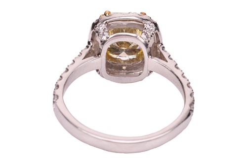 Lot 193 - A Fancy Intense yellow diamond cluster ring,...