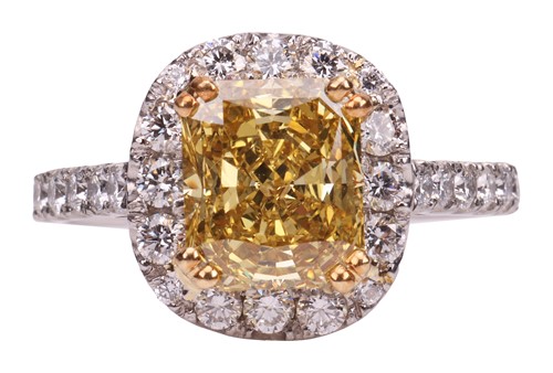 Lot 193 - A Fancy Intense yellow diamond cluster ring,...