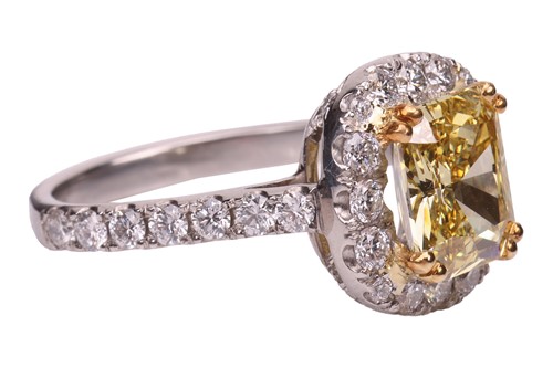 Lot 193 - A Fancy Intense yellow diamond cluster ring,...