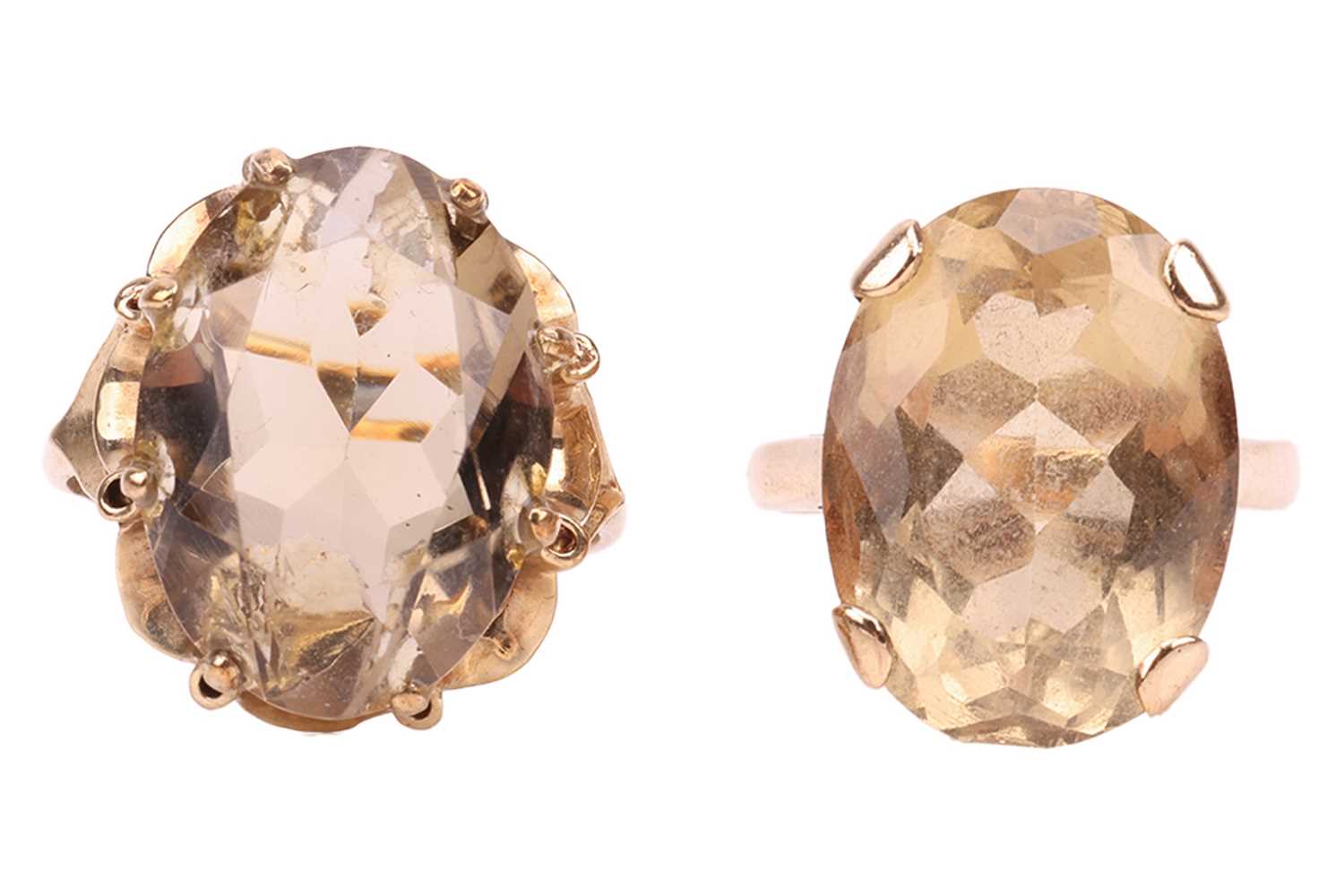 Lot 17 - Two 9ct gold citrine dress rings; the first...