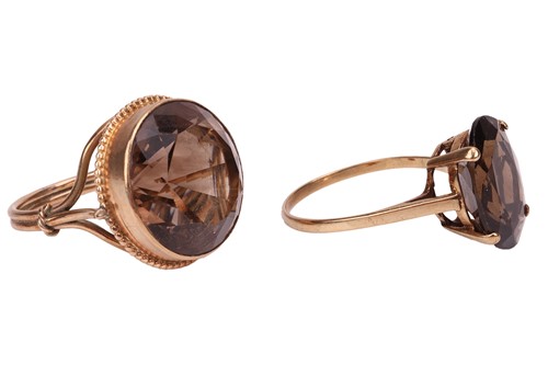 Lot 35 - Two smoky quartz rings; the first contains a...
