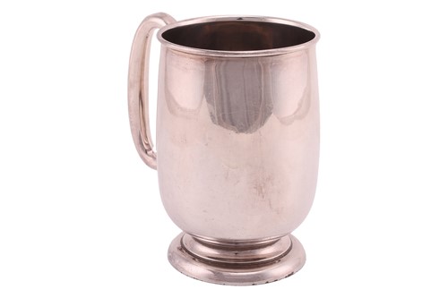 Lot 415 - A silver pint tankard, polished plain body...