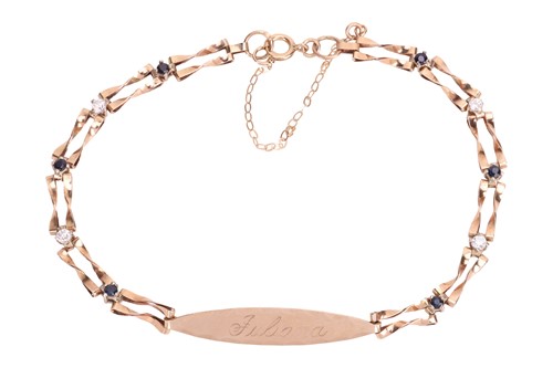 Lot 122 - A gem-set name tag bracelet in 9ct gold, the...