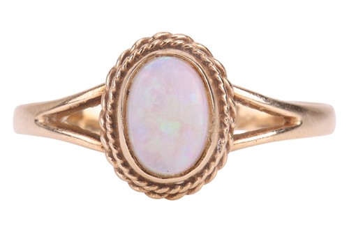 Lot 22 - A 9ct gold opal ring, featuring an oval opal...