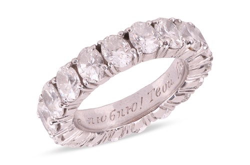 Lot 199 - An oval-cut diamond eternity ring, comprising...