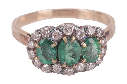 Lot 144 - An emerald and diamond cluster ring, composed...
