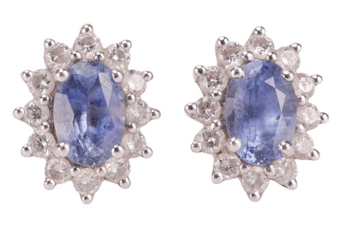 Lot 115 - A pair of sapphire and diamond cluster...