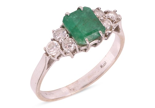 Lot 140 - An emerald and diamond ring, the claw-set step-...