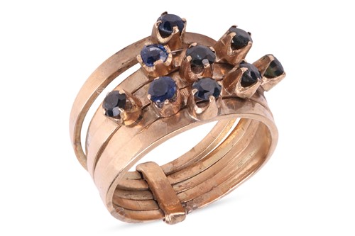 Lot 132 - A five row sapphire ring, each polished band...