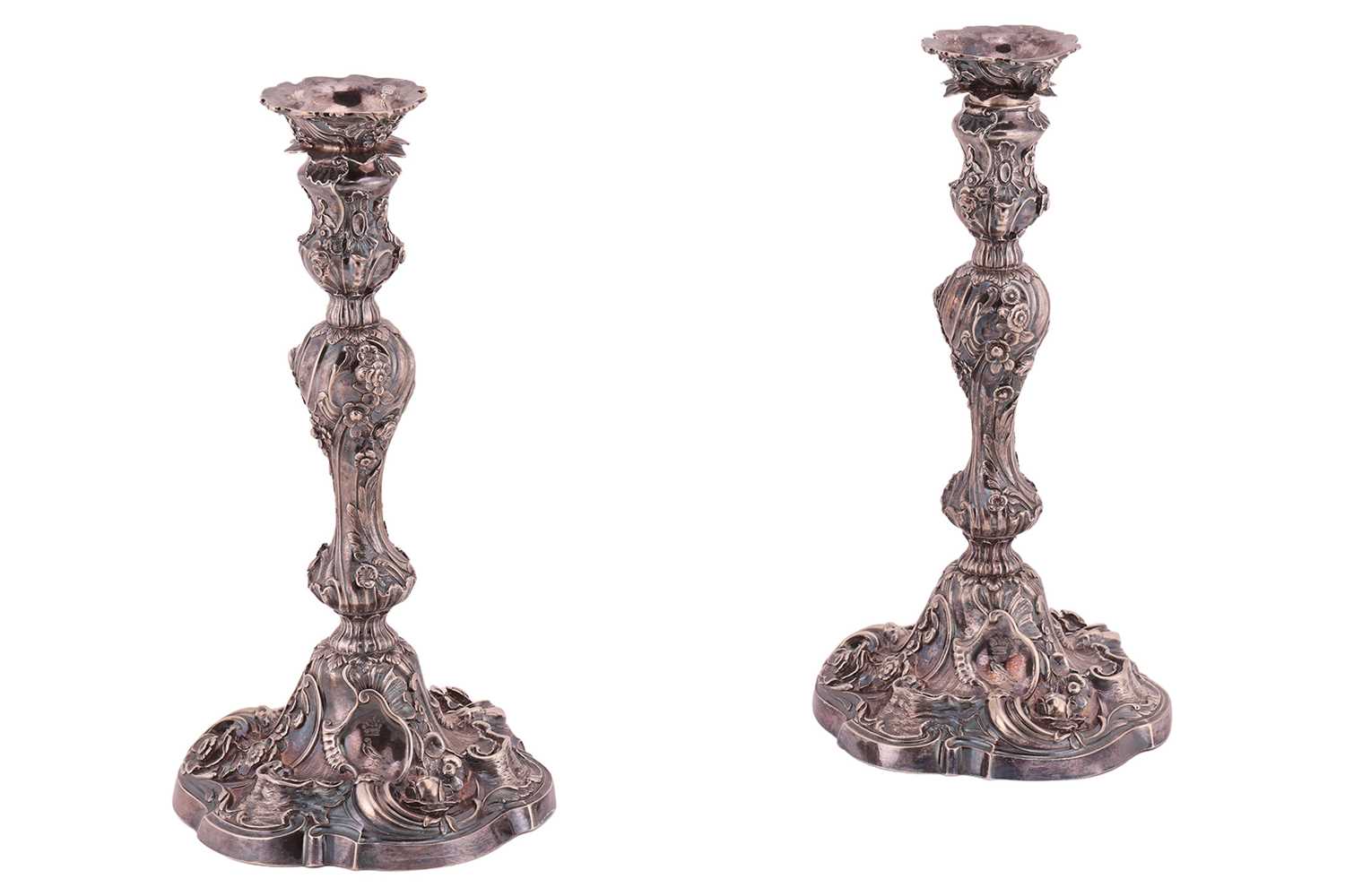 Lot 320 - A pair of George II silver cast candlesticks,...