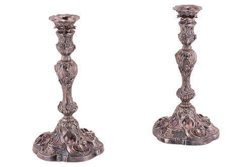 Lot 320 - A pair of George II silver cast candlesticks,...