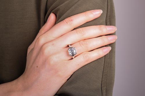 Lot 206 - An emerald-cut diamond ring, featuring an...