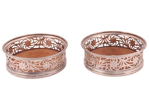 Lot 334 - A pair of George III silver wine coasters,...