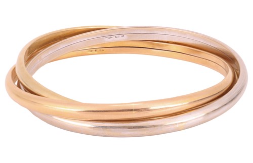 Lot 125 - An 18ct gold tri colour bangle, consisting of...