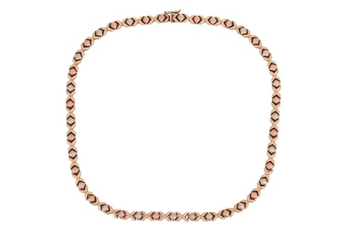 Lot 84 - A tri-colour necklace, featuring cross motifs...