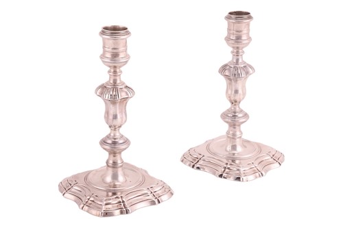 Lot 318 - A pair of George II silver cast candlesticks,...