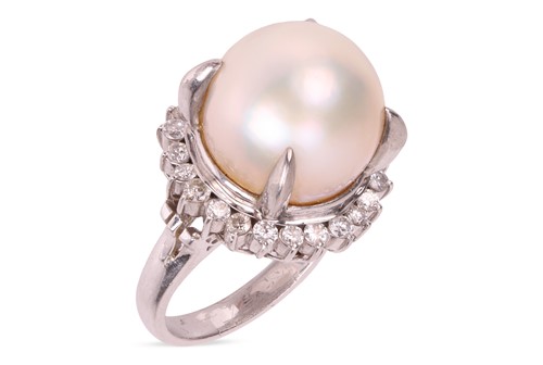 Lot 173 - A pearl and diamond ring, featuring a central...