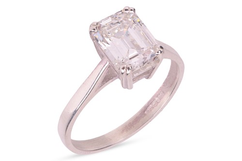 Lot 189 - An emerald-cut diamond solitaire ring,...