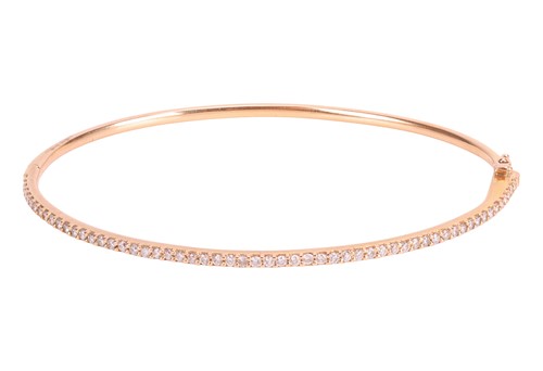 Lot 111 - A diamond-set hinged bangle, half-set with...