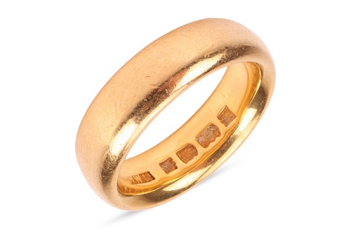 Lot 142 - A 22ct gold band ring, the polished hoop,...